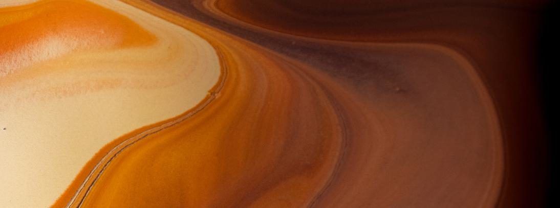 Swirling layers of rock in beige, orange and brown tones