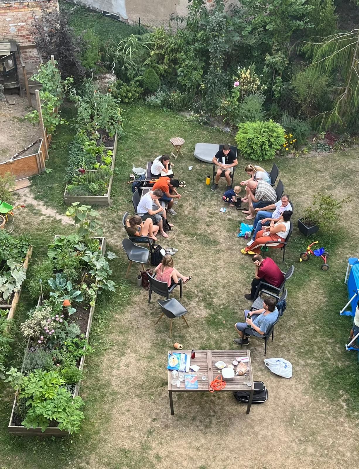 View from above of a group sitting together in a garden